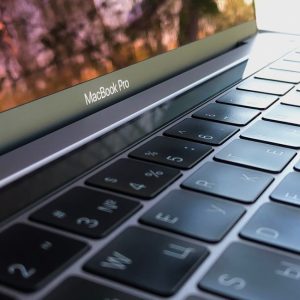 A detailed close-up of a MacBook Pro keyboard, highlighting keys and reflection.