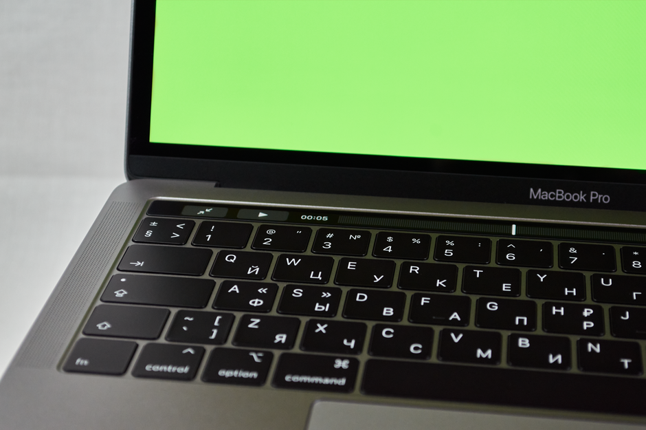 Apple MacBook Pro 35,97cm (14,2") űrfekete 1 Russian keyboard MacBook Pro with a green screen. Modern electronic device.