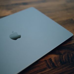 Close-up of a sleek modern laptop with minimalistic design on a wooden table surface.