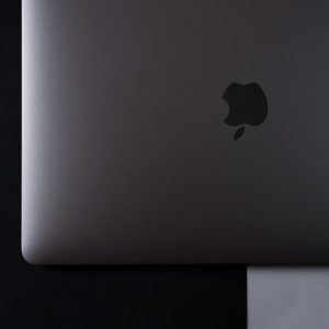 A minimalist top-down view of a laptop set against a black and white background.